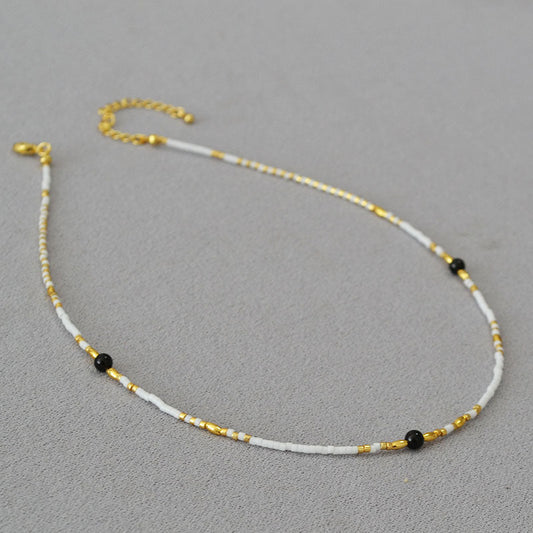 Gold and White Beaded Necklace with Black Accents
